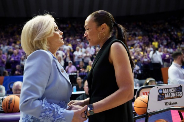 LSU head coach Kim Mulkey, left, greets San Diego State head coach Stacie Terry-Hutson in the first round of the NCAA college basketball tournament, Saturday, March 22, 2025, in Baton Rouge, La. (AP Photo/Matthew Hinton)