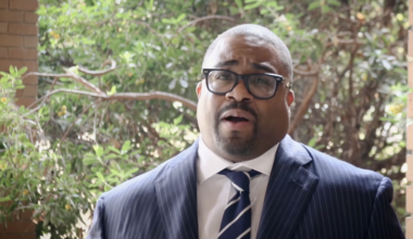 A man in glasses and a suit and tie