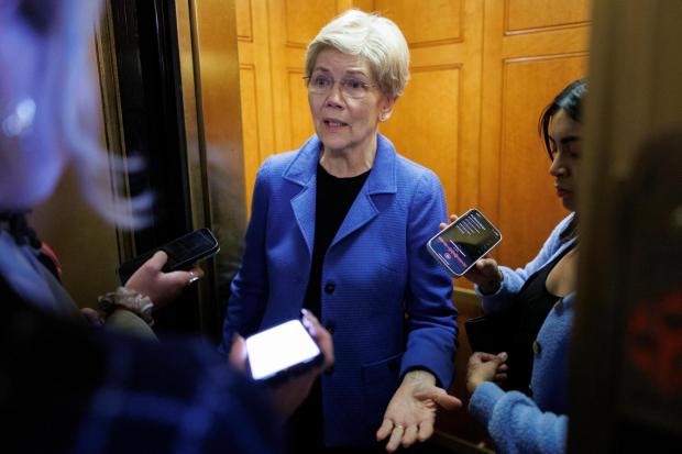 Sen. Elizabeth Warren, D-Mass., speaks to reporters outside the Senate Chamber, following a vote on Capitol Hill in Washington, Saturday, March 21, 2026. (AP Photo/Tom Brenner)