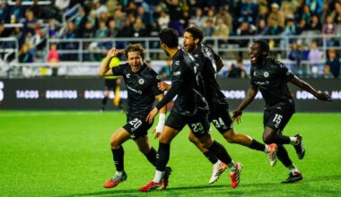 Alameda Post - Four Oakland Roots players run and celebrate in a game against Monterey Bay FC.