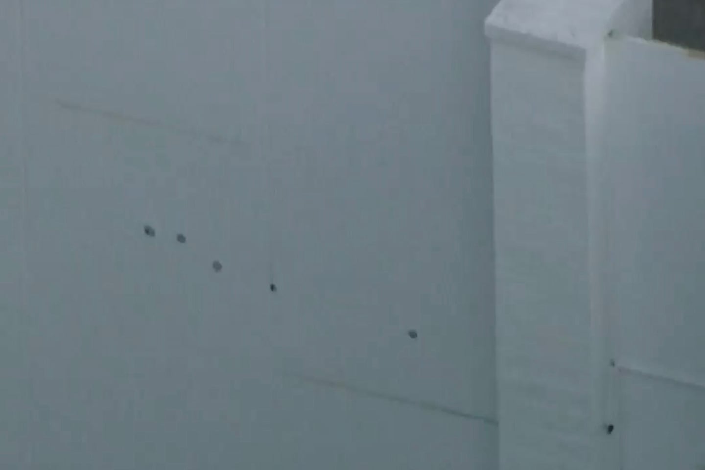 This image taken from video provided by ABC7 Los Angeles on Monday shows what appears to be bullet holes on a wall at singer Rihanna's home in Los Angeles.