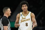 FiLE - San Francisco forward David Fuchs (8) talks with an official during an NCAA college basketball game against Gonzaga in San Francisco, Wednesday, Feb. 18, 2026.