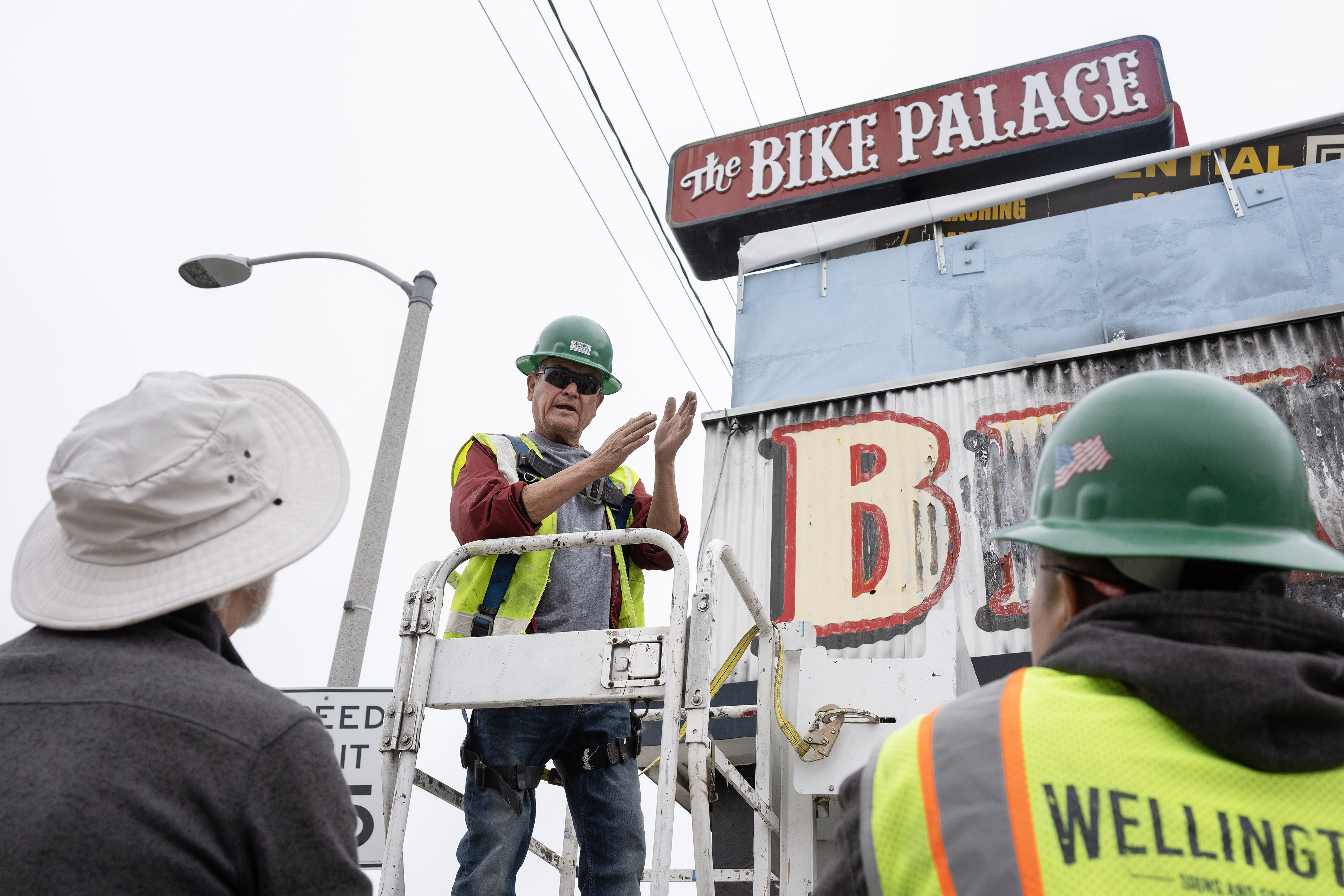 Tony Paze, center, describes how he plans to remove the...