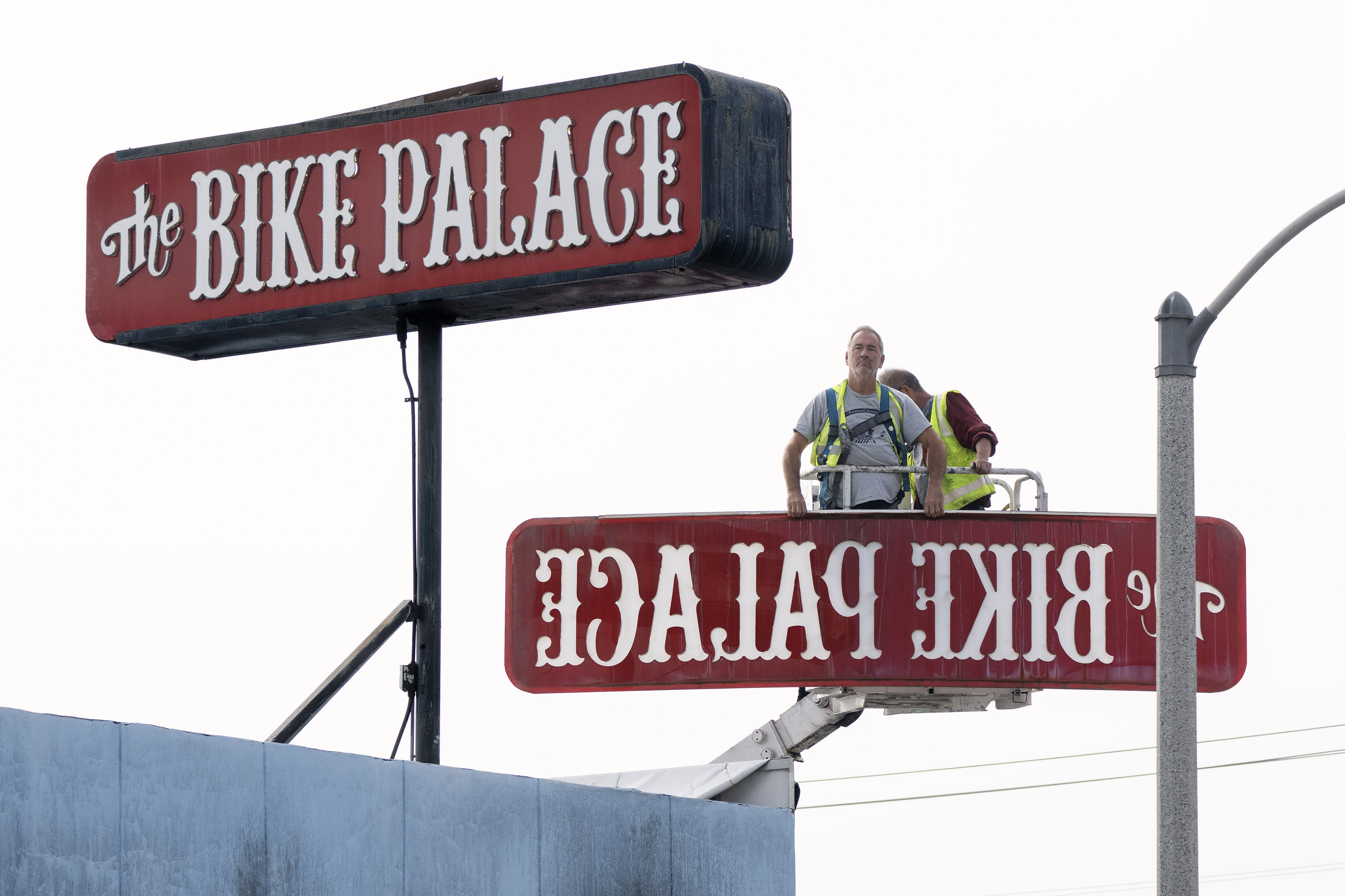From left, Randy Weston and Tony Paze remove the iconic...