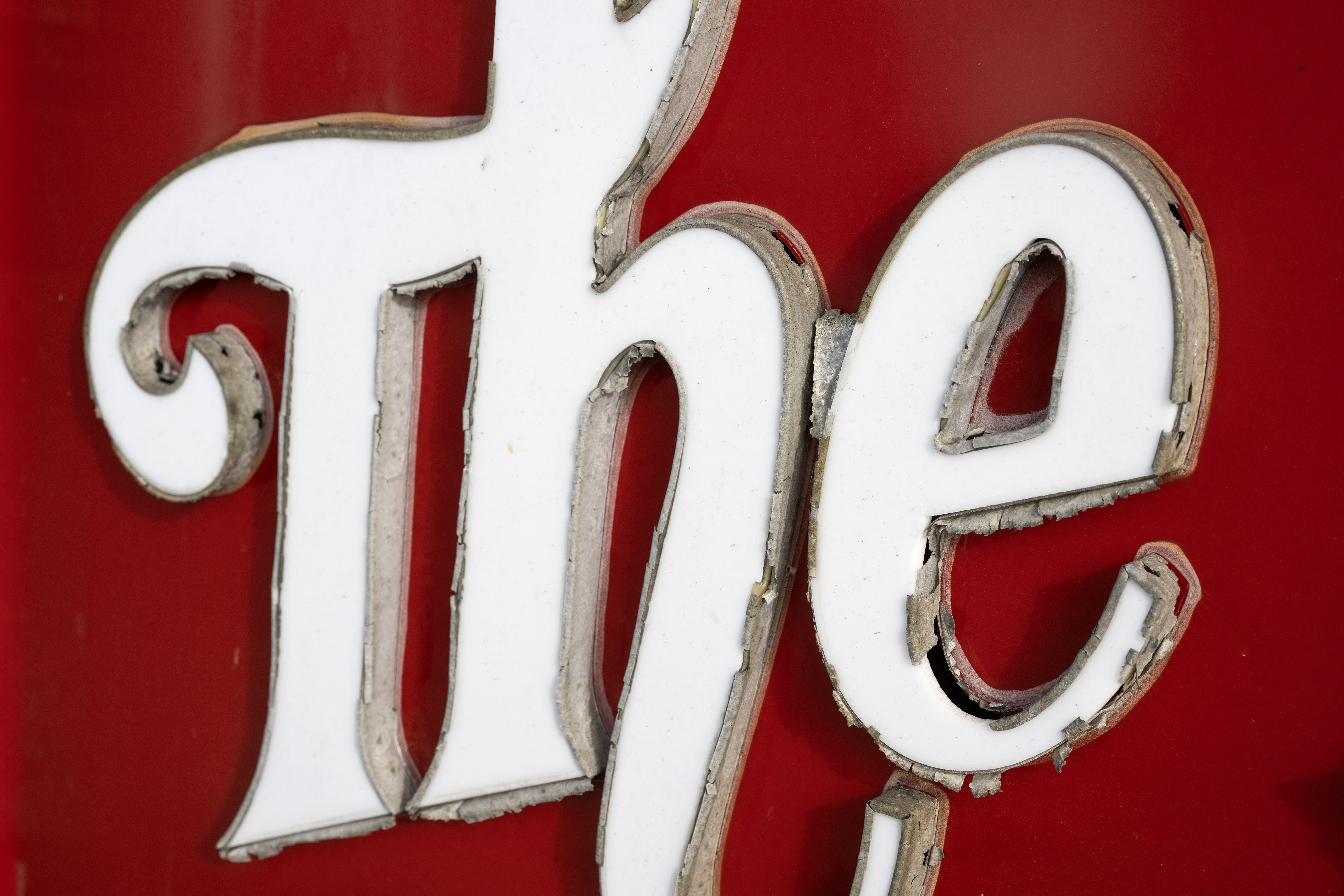 The iconic Bike Palace sign shows signs of wear on...