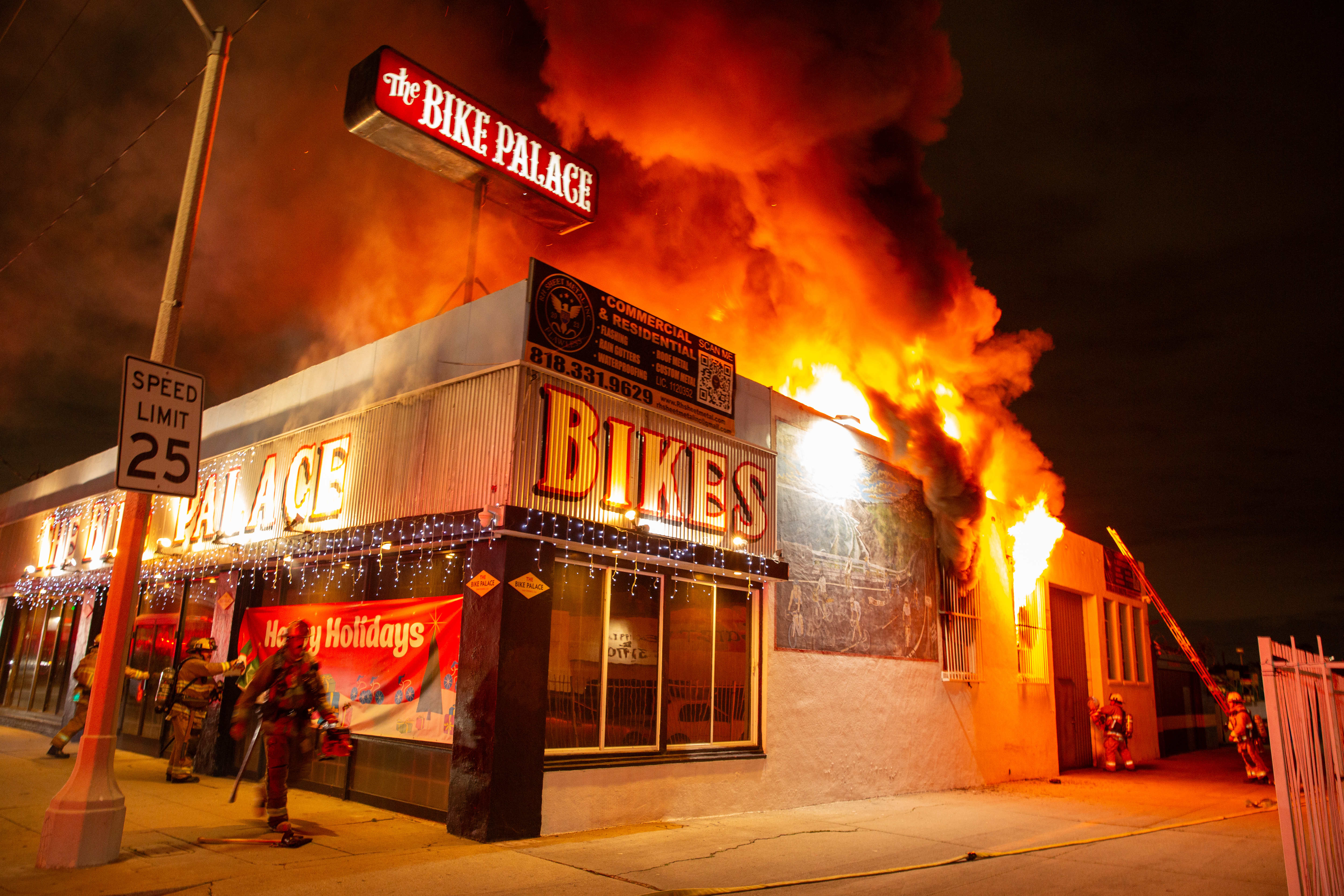 Firefighters battle a blaze at The Bike Palace bicycle shop...