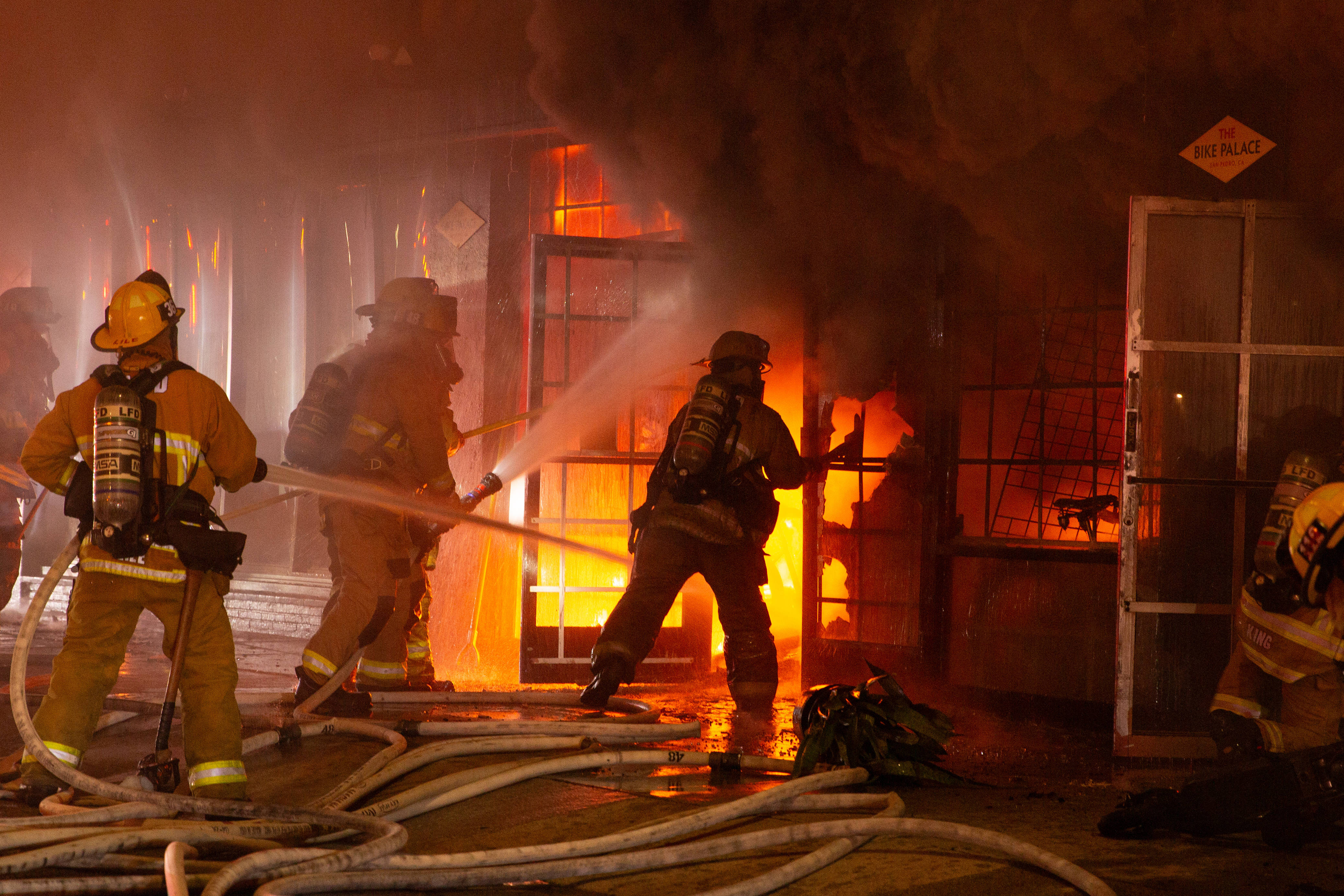Firefighters battle a blaze in The Bike Palace bicycle shop...