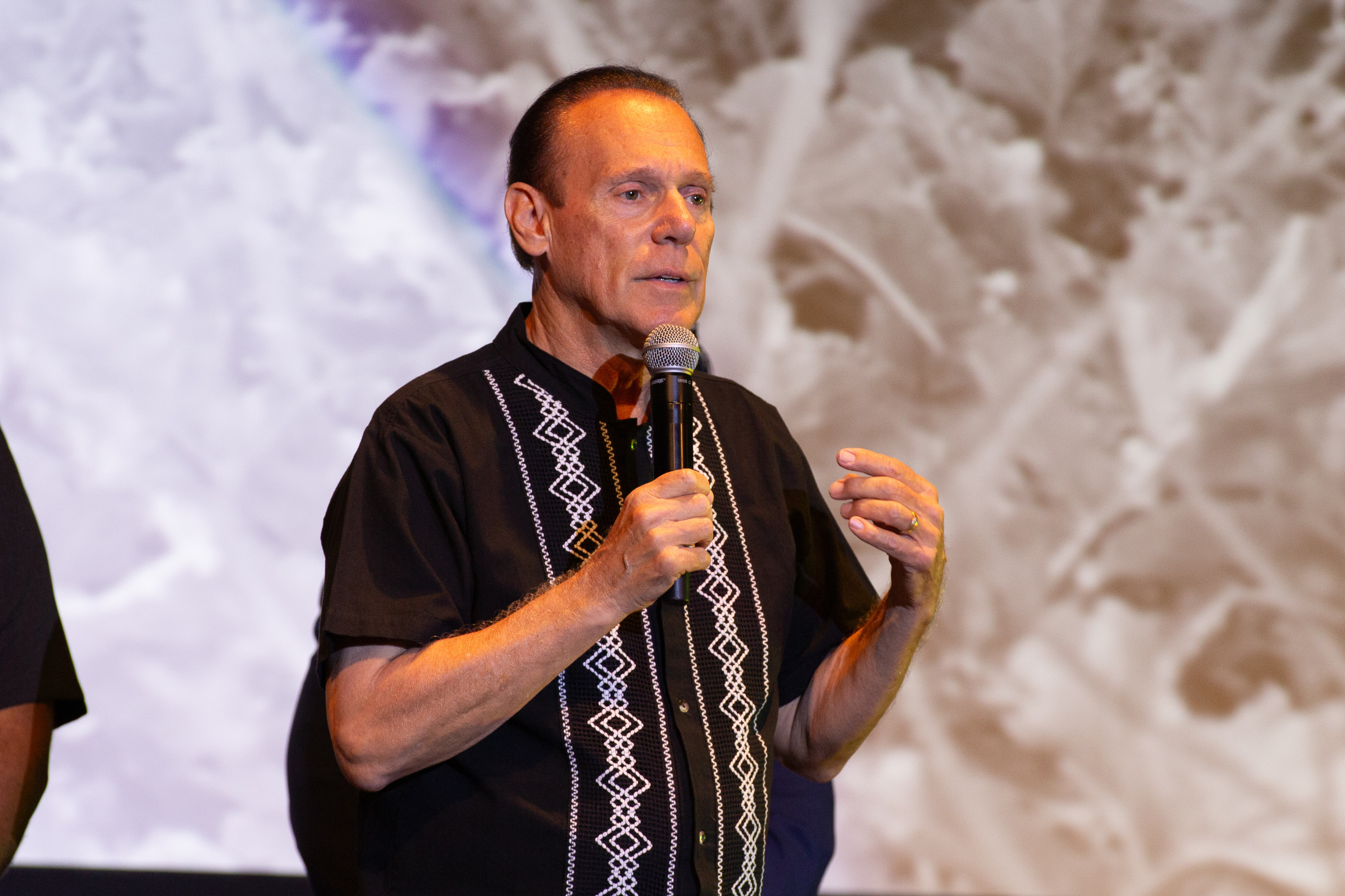 Councilmember Jim Dear speaks to the audience during the United...