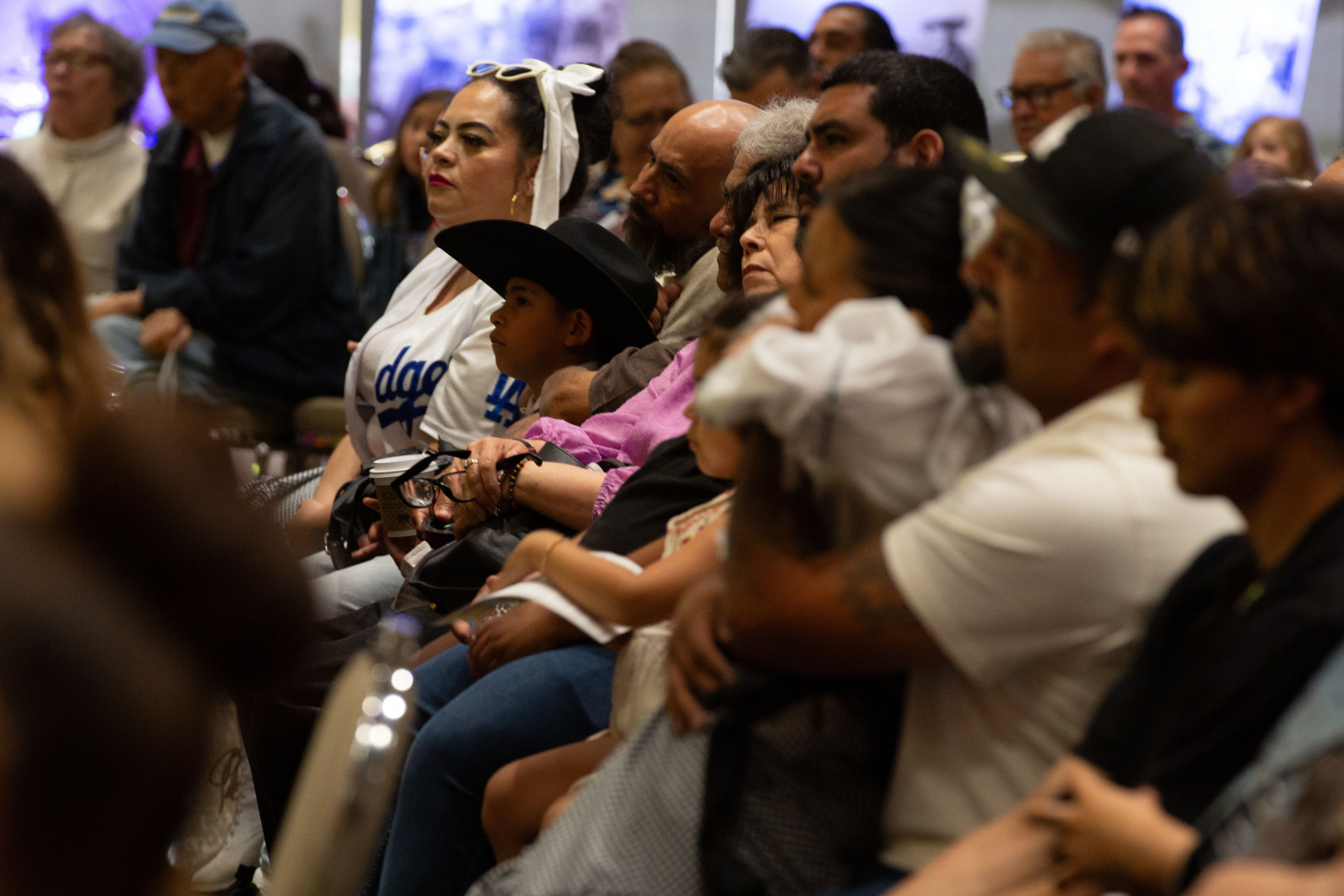 Audience members listen to a keynote speech by veteran journalist...