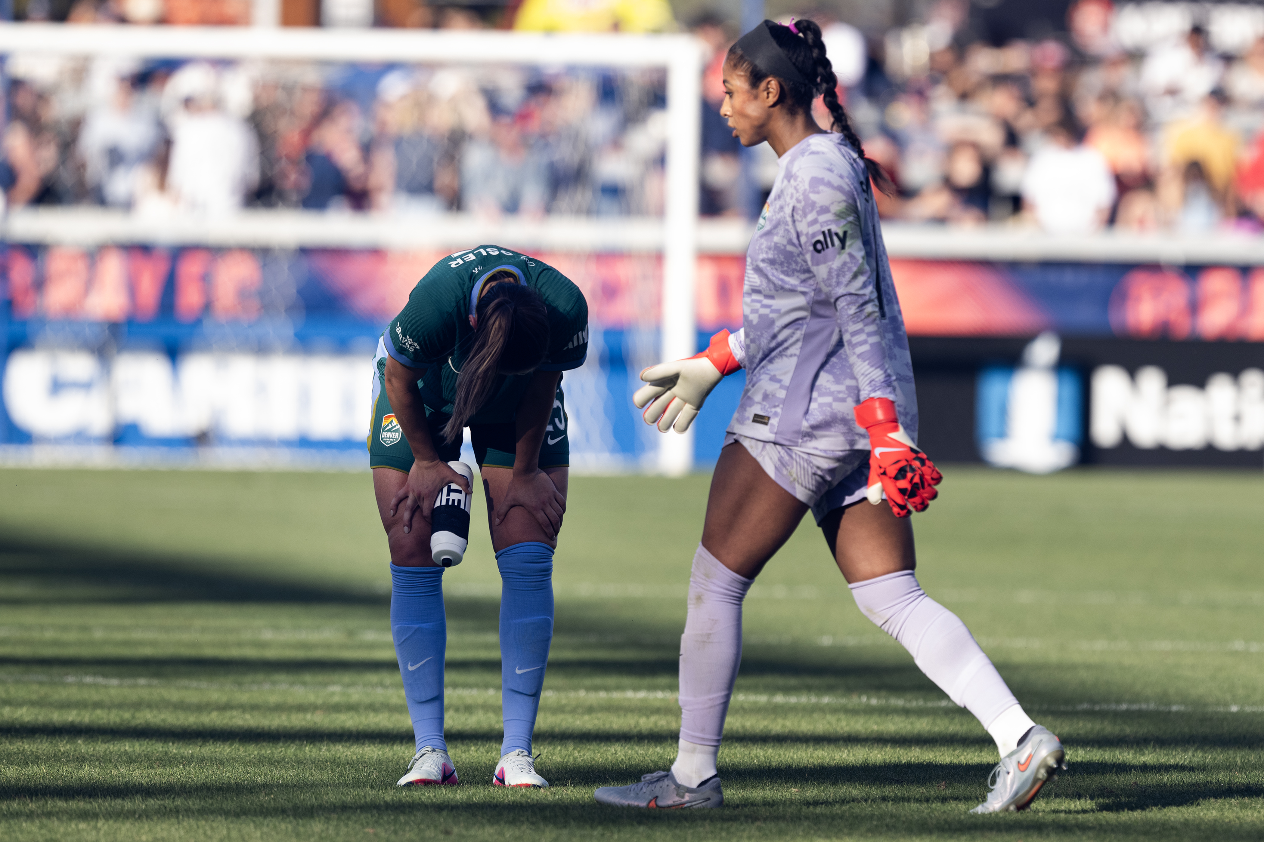 Abby Smith (1) of the Denver Summit FC somewhat comforts...