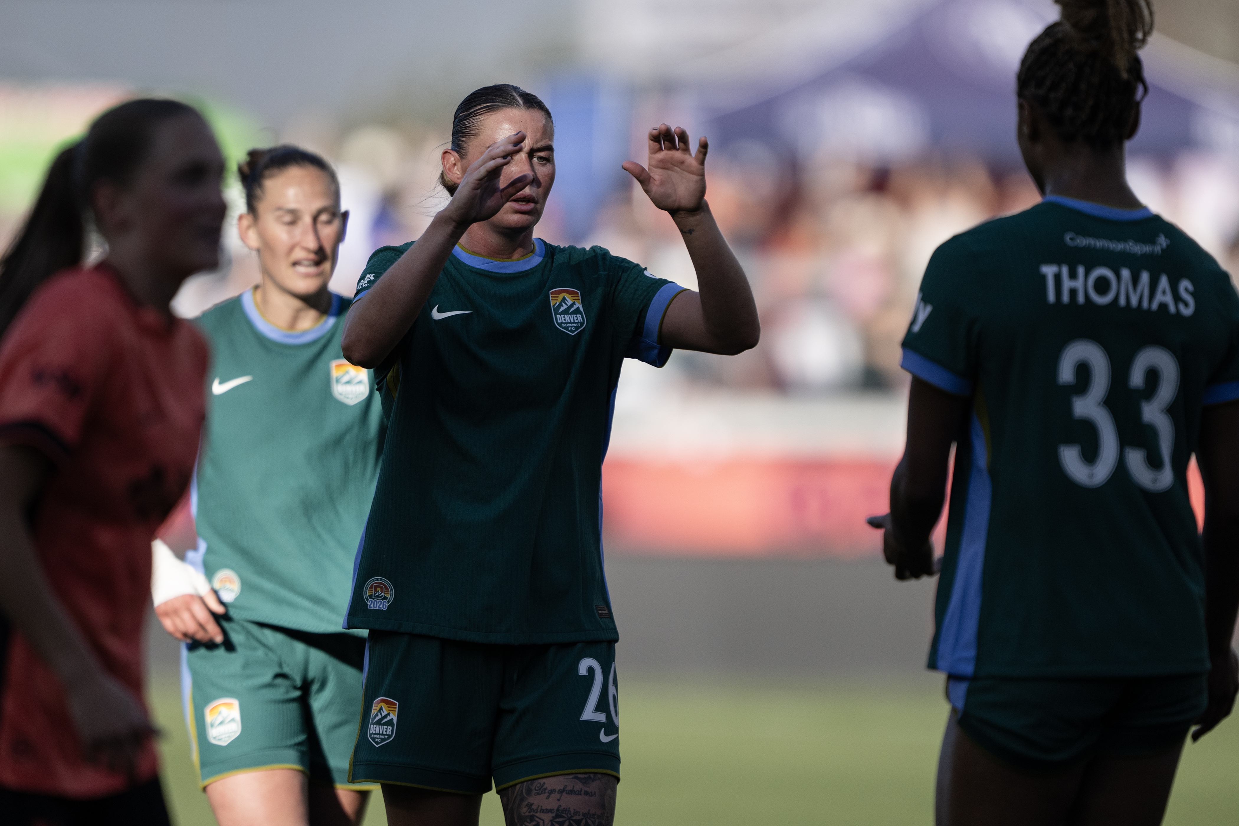 Natasha Flint (26) greets Olivia Thomas (33) of the Denver...