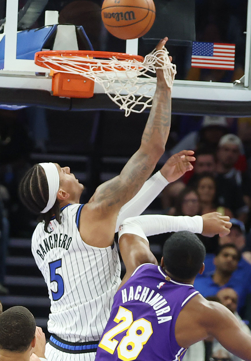 Orlando forward Paolo Banchero (5) leaps for a rebound over...