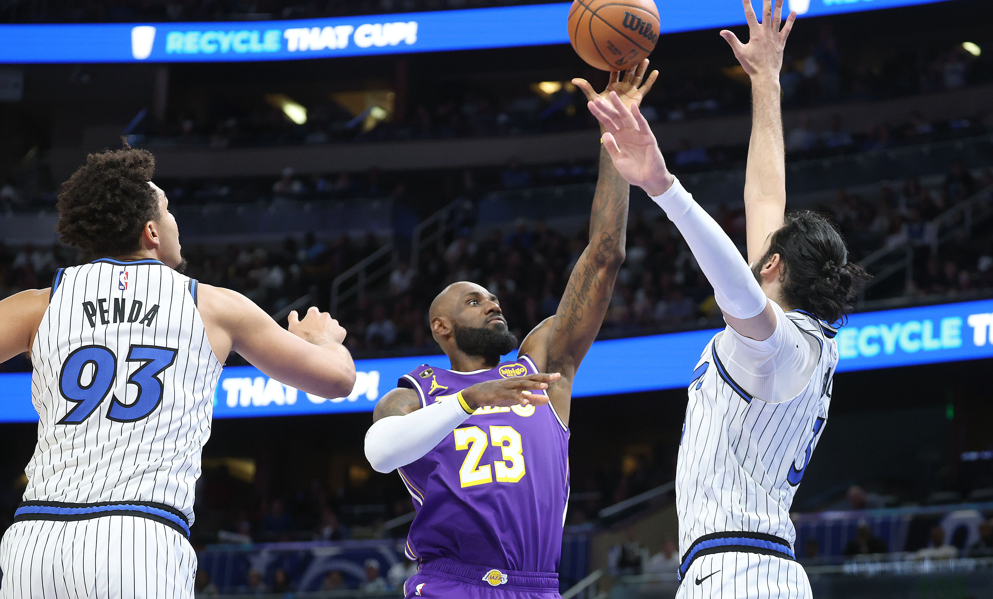 LA forward LeBron James (23) shoots between Orlando forward Noah...