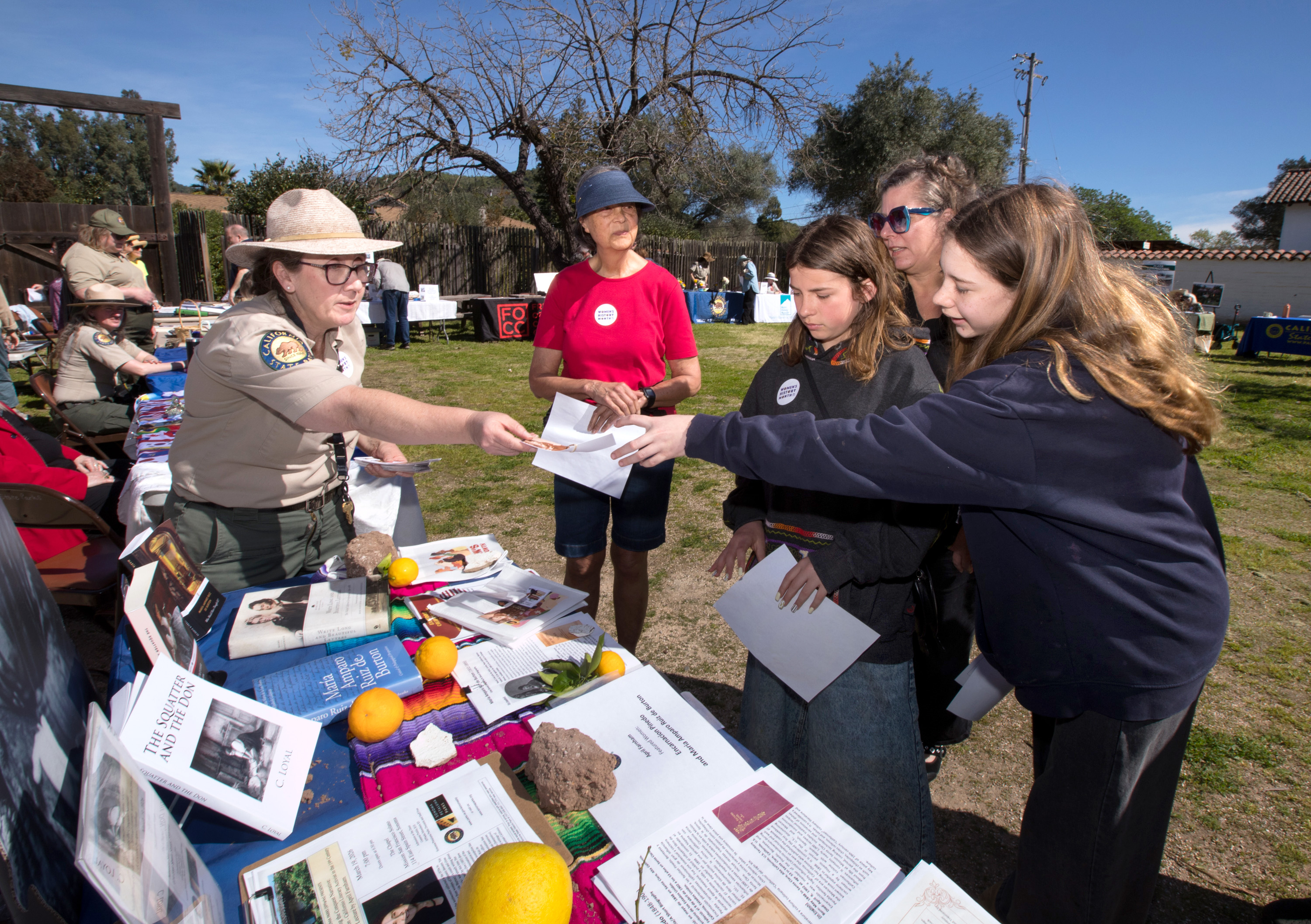 April Farnham, a California State Parks interpreter, hands out information...
