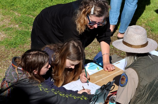 From left, Penelope Poulos, 11, and sister, Lilliann Poulos, 12, and their mother, Jodi Volovick, all of Kenwood, make sketches as they take part in activities during the Second Annual Women's History Crawl in celebration of Women's History Month at Sonoma State Historic Park in Sonoma, Saturday, March 7, 2026. Participants take part in activities to complete bingo cards and win donated prizes.(Darryl Bush/For The Press Democrat)