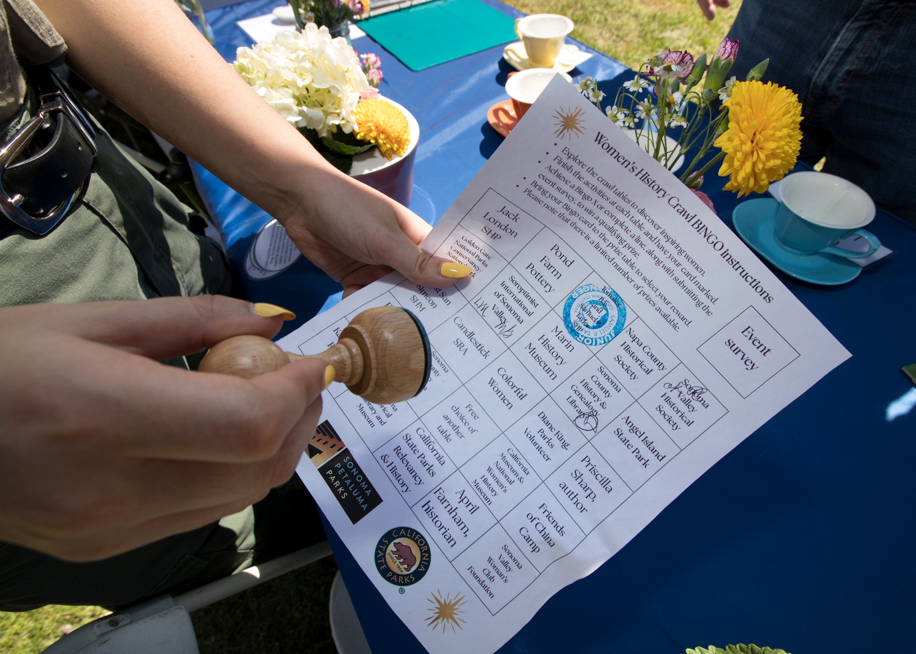 A park interpreter stamps a guest's bingo card during the...