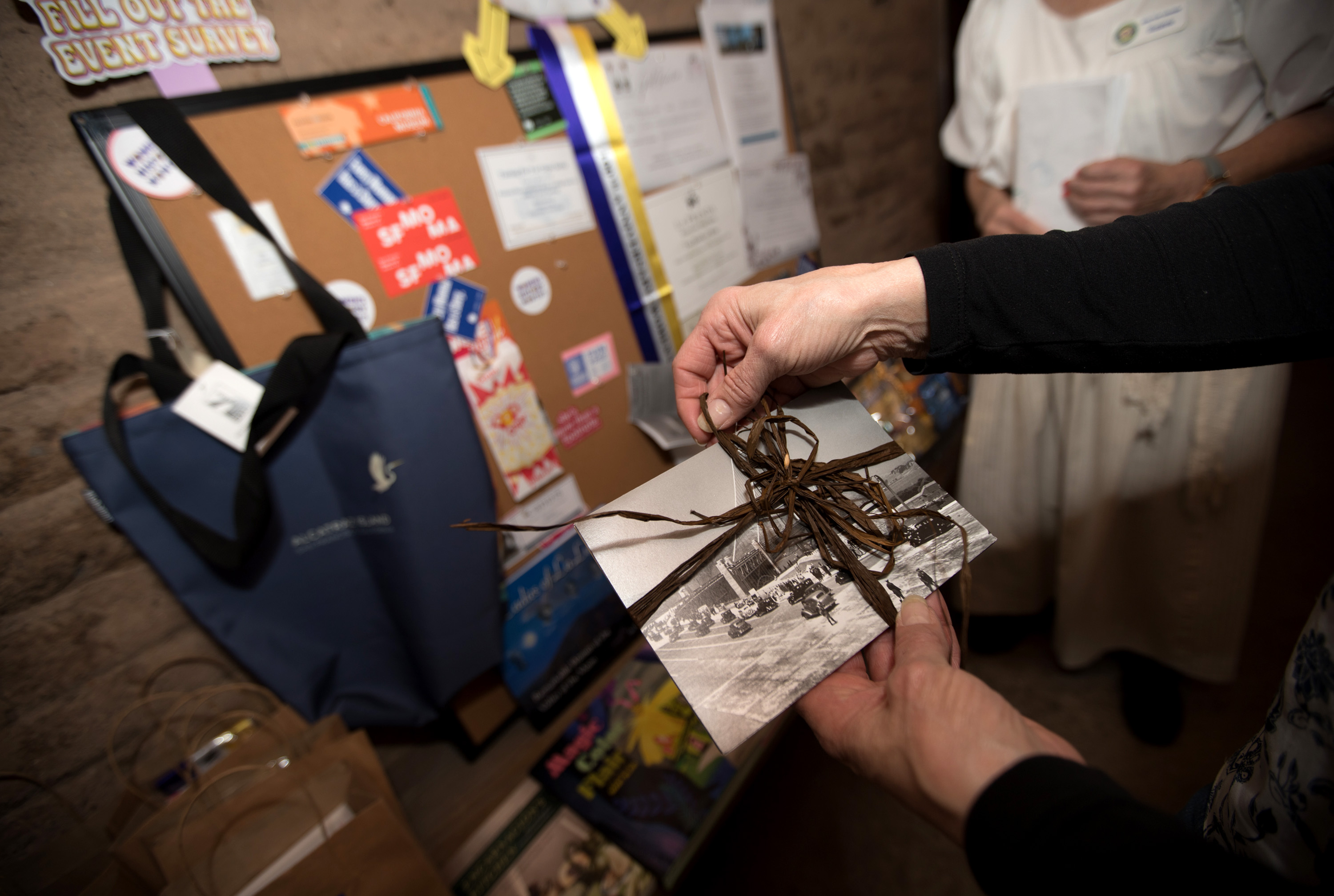 A guest holds historic post cards, one of many prizes...