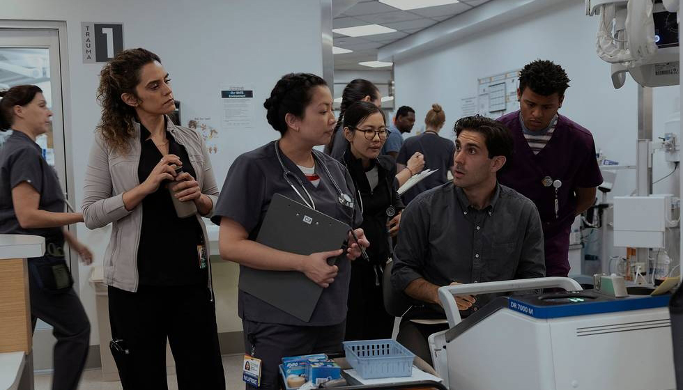 A small group of medical staff in The Pitt discuss medical equipment.