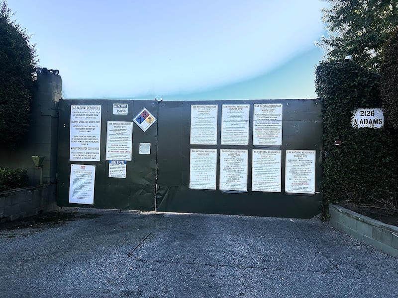 Photo of a green door to an oil drilling site.