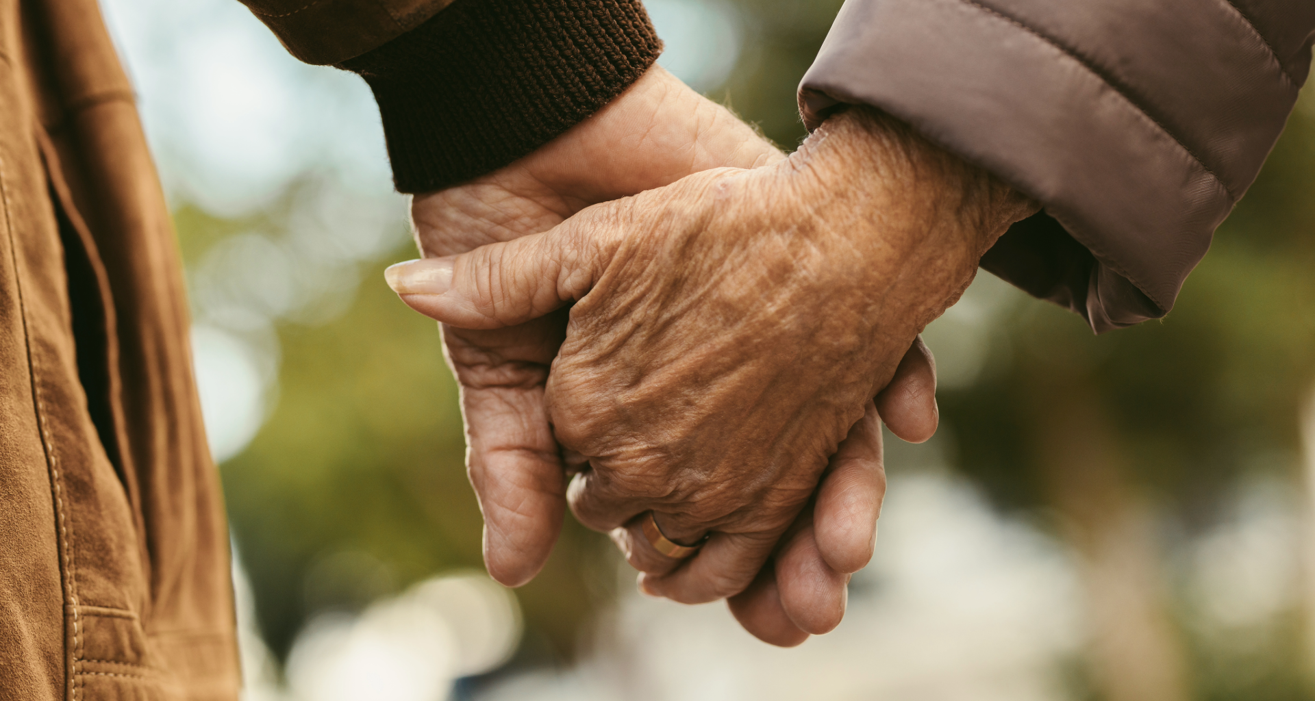 Elderly people holding hands