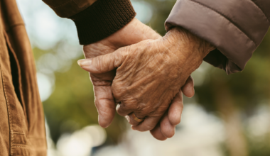 Elderly people holding hands