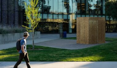 A student looks toward a plywood box covering a statue of César Chavez at California State University, Fresno in Fresno, Calif., on March 18.