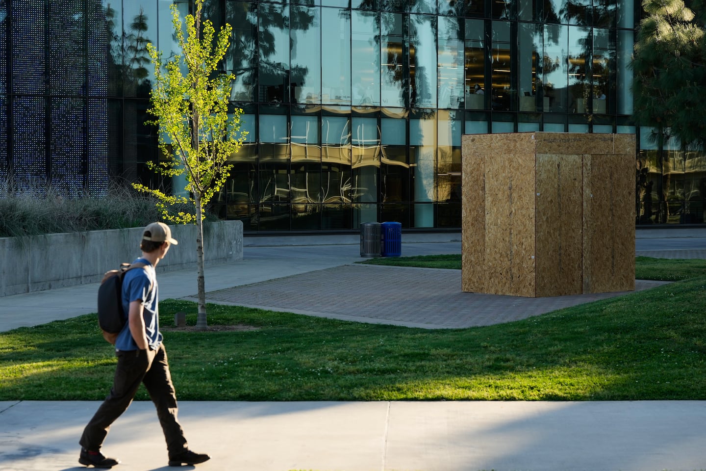 A student looks toward a plywood box covering a statue of César Chavez at California State University, Fresno in Fresno, Calif., on March 18.