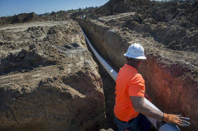A construction worker installs electrical conduit at The Cannery housing development in Davis in 2015. CEQA’s critics say it’s used to delay and add costs to new housing and infrastructure, while its backers argue it helps protect California’s environment and community health.