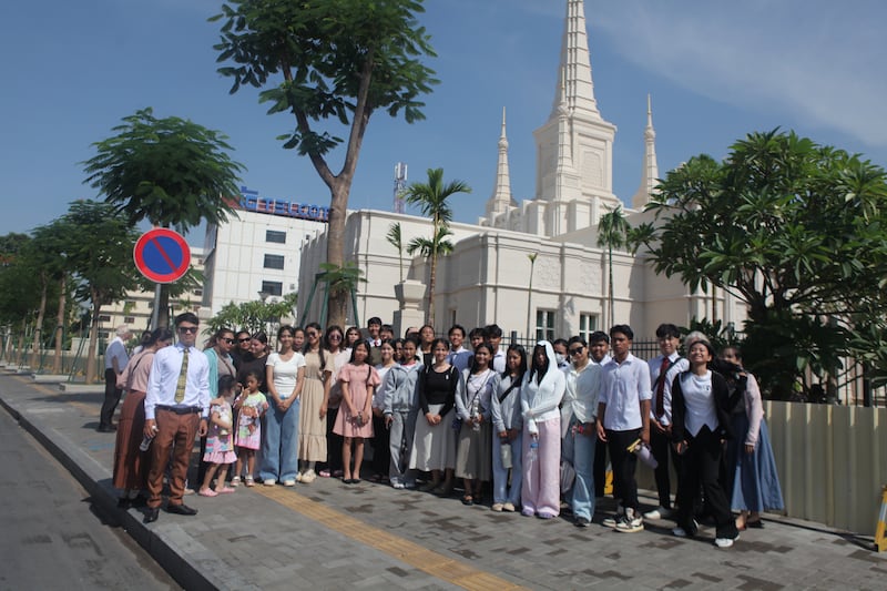 Youth and leaders pose for a photo in front of the Phnom Penh Cambodia Temple, which is under construction, on June 18, 2025.