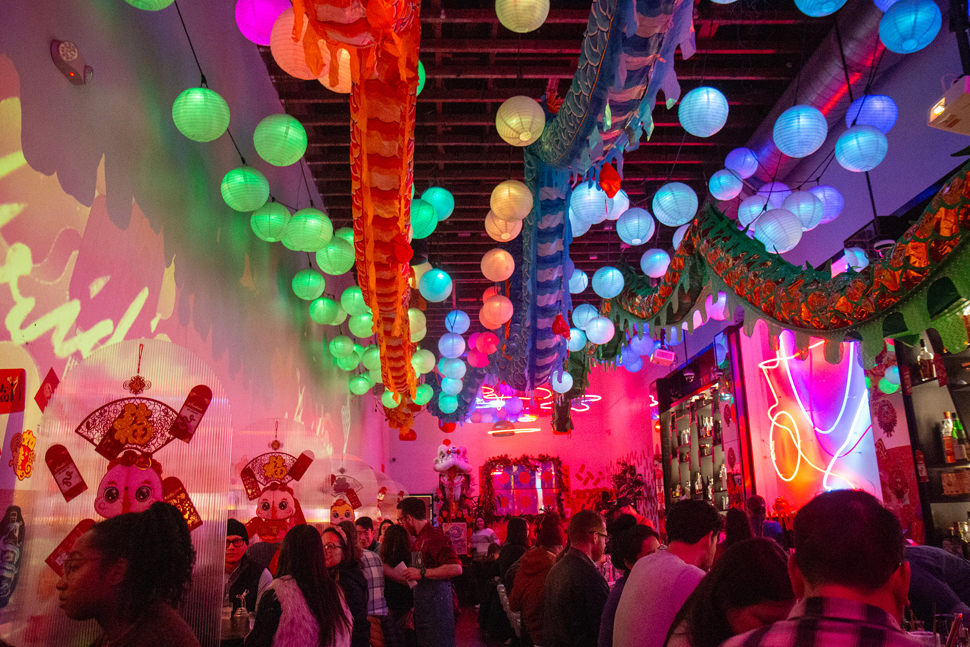 Interior of a stylish, fluorescent-lit bar decorated for Lunar New Year.
