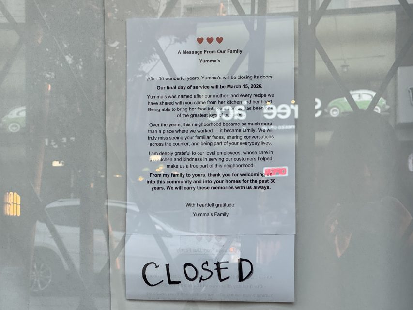 A printed letter on a glass door announces the permanent closure of Yumma's restaurant after 30 years, with a "CLOSED" sign written below in black marker.