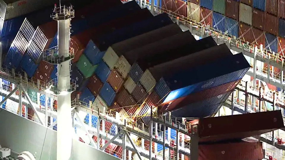 Containers dangle from cargo ship in Port of Long Beach