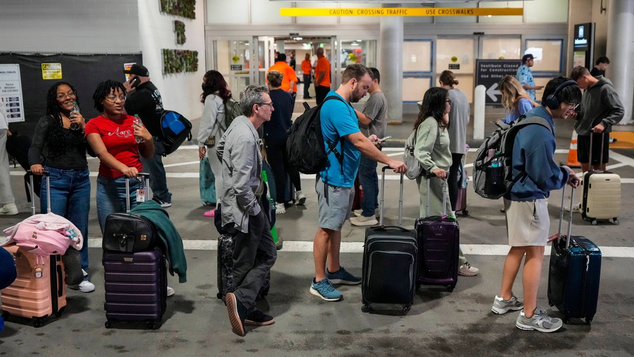 Airline passengers wait in long lines outside the terminal to get through the TSA security screening at William P. Hobby Airport in Houston, Sunday, March 8, 2026. (Brett Coomer/Houston Chronicle via AP)