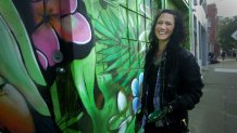 Mural artist Amanda Lynn touches up one of her murals in San Francisco’s SoMa District.
