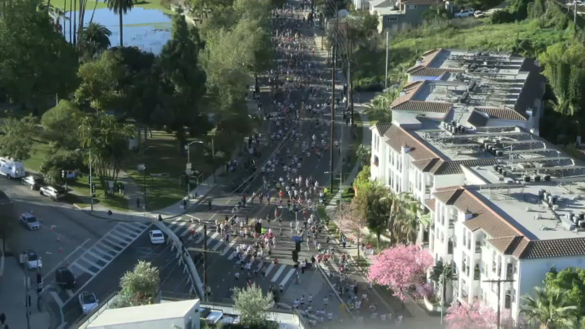 Runners zoom by Echo Park Lake.