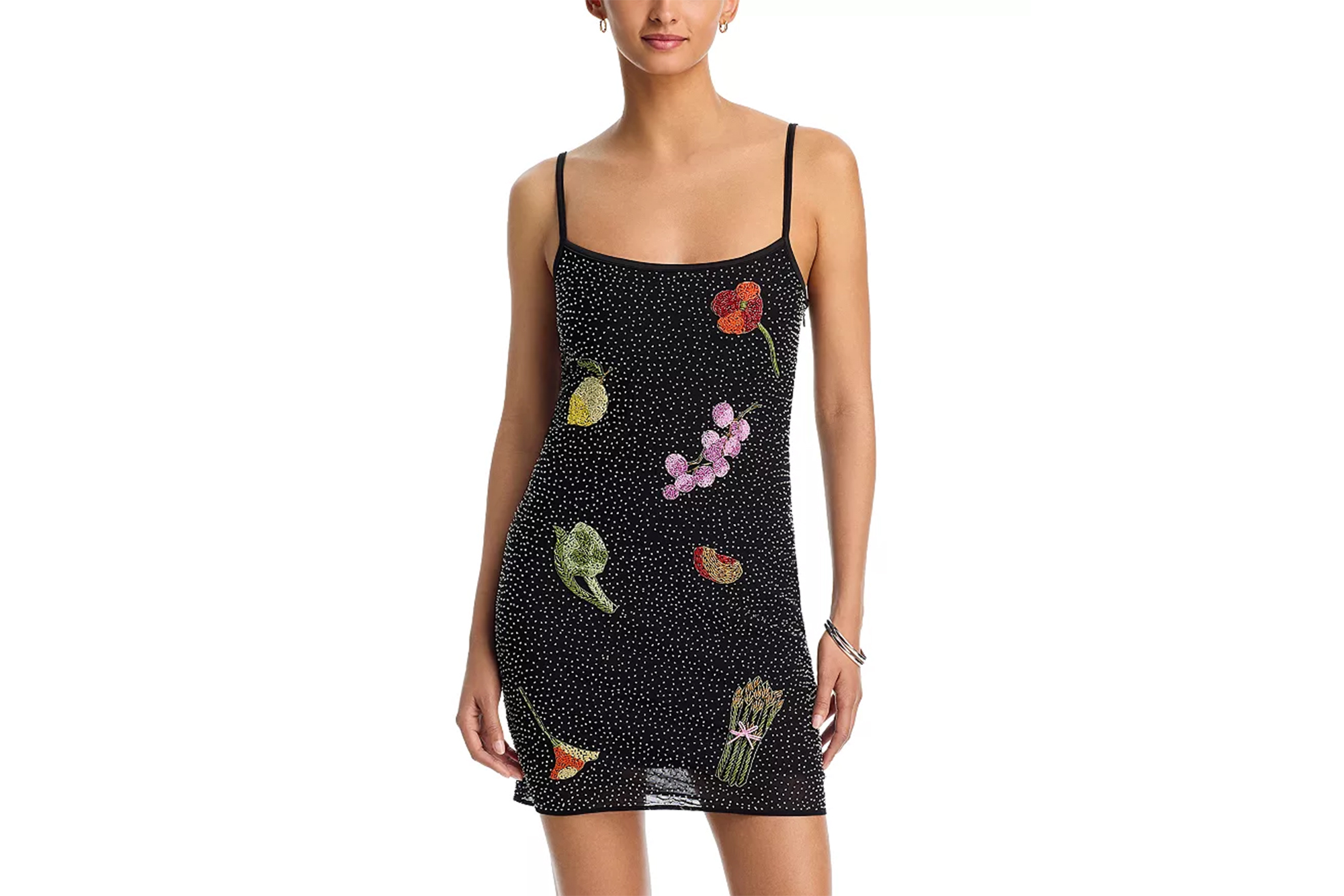 Black mini dress with spaghetti straps and fruit and vegetable embellishments.