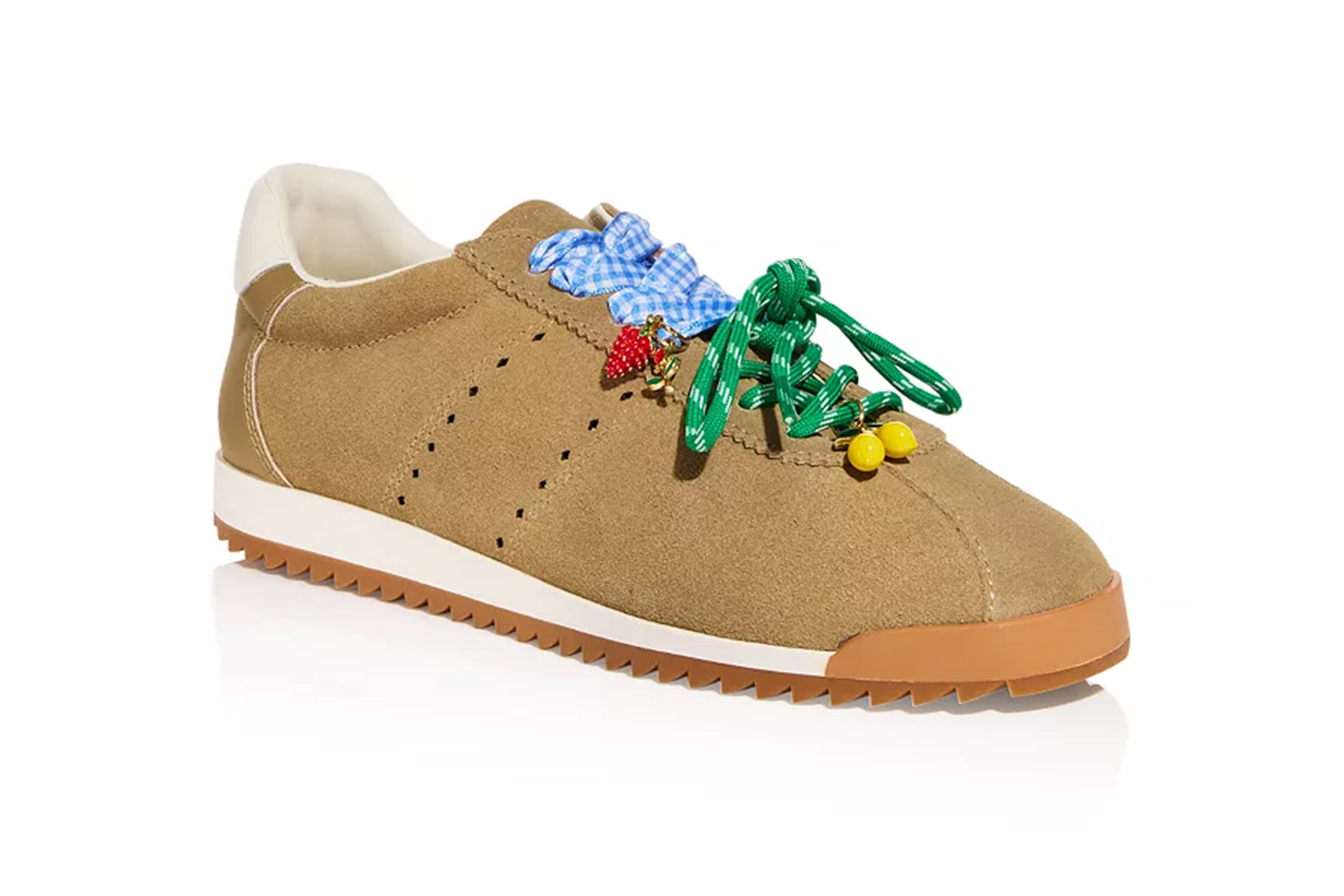 A tan suede sneaker with green laces, two blue gingham bows, a strawberry charm, and two lemon charms.