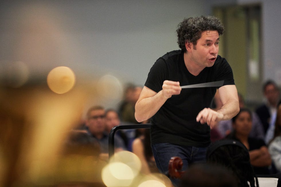 Conductor leading an orchestra rehearsal.