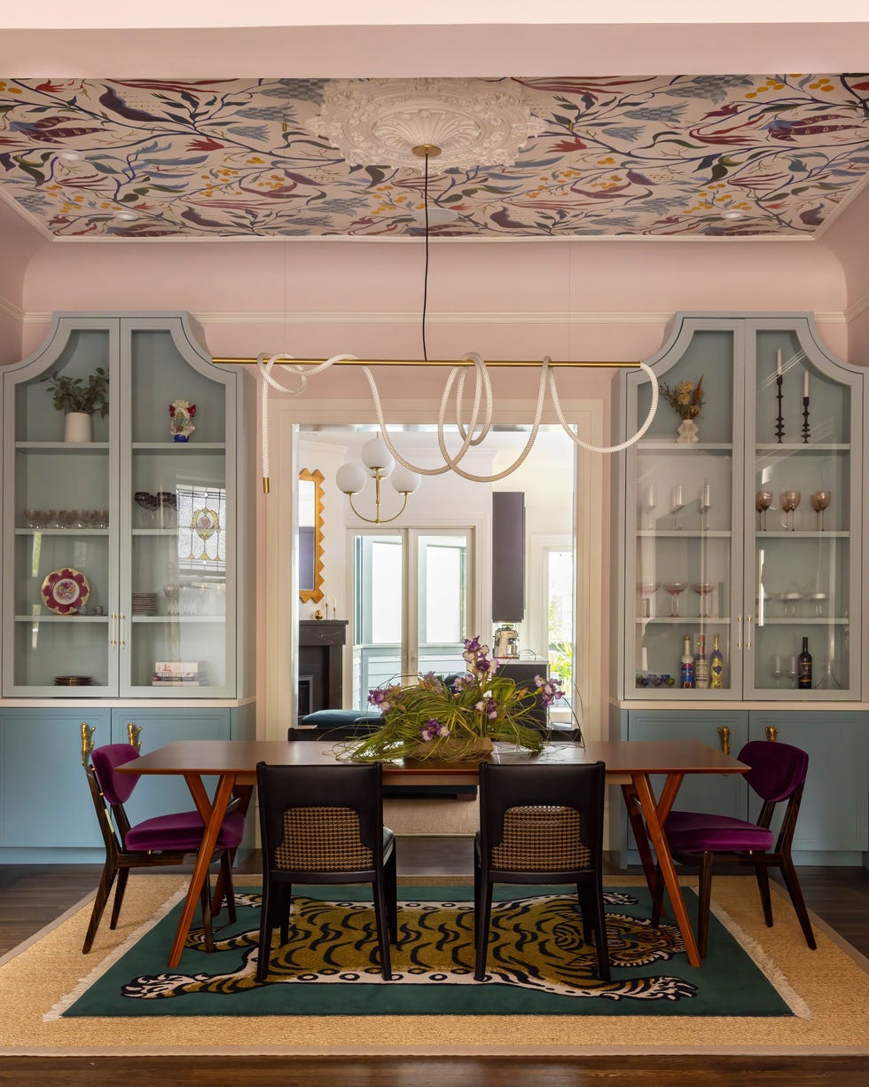 A dining area with a modern aesthetic featuring a table and chairs.
