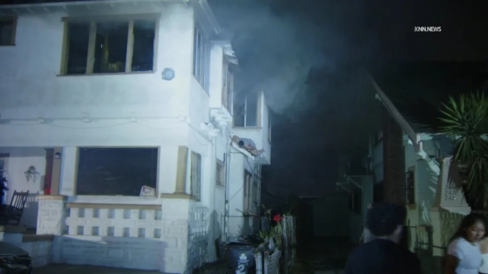 A woman jumps from a second story window to escape a fire in Historic South-Central Los Angeles