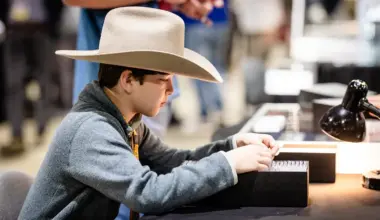 Young Collector looking throuch box of coins. Now this young man is serious,