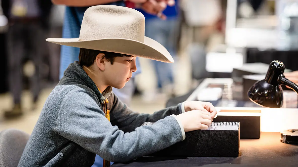 Young Collector looking throuch box of coins. Now this young man is serious,