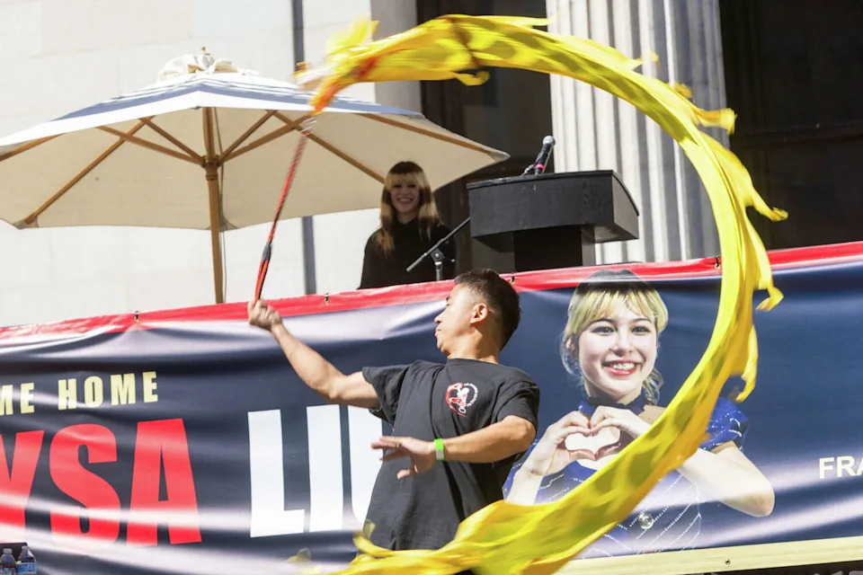 A U.S. Shaolin Kung Fu dancer performs while Olympic gold medalist Alysa Liu looks on during the Alysa Liu Celebration Rally at Frank Ogawa Plaza in front of Oakland City Hall in Oakland, Calif., on March 12, 2026. (Douglas Zimmerman/SFGATE)