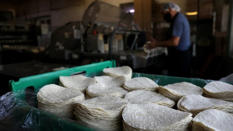 Corn tortillas are stacked inside of La Gloria Mexican Foods, one of the oldest tortilla factories in the city. - Christina House/Los Angeles Times/Getty Images