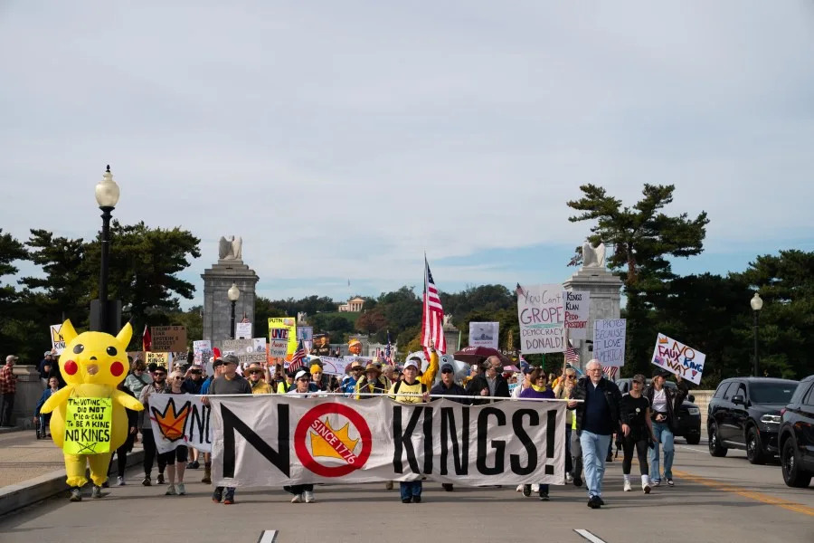 Crowds cross the memorial bridge as part of a No Kings protest, Saturday, Oct. 18, 2025, in Washington. (AP Photo/Allison Robbert)