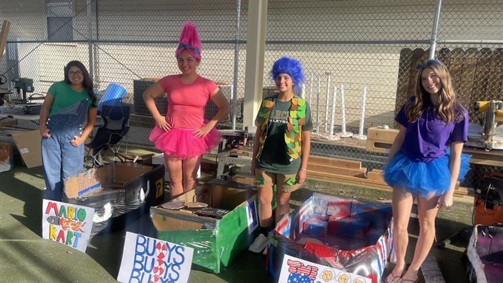 Students are Garces Memorial High School pose in front of their cardboard boats ahead of the canoe races. PHOTO: KBAK/KBFX{p}{/p}
