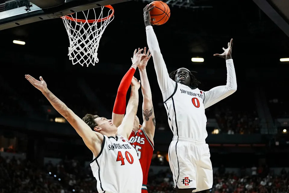 San Diego forward State Magoon Swath (0) and Miles Heide (40) block a shot from New Mexico JT Rock (35) during the semifinal of Mountain West Championship tournament game between San Diego State and New Mexico on Friday March 13, 2026 in Las Vegas, Nev.