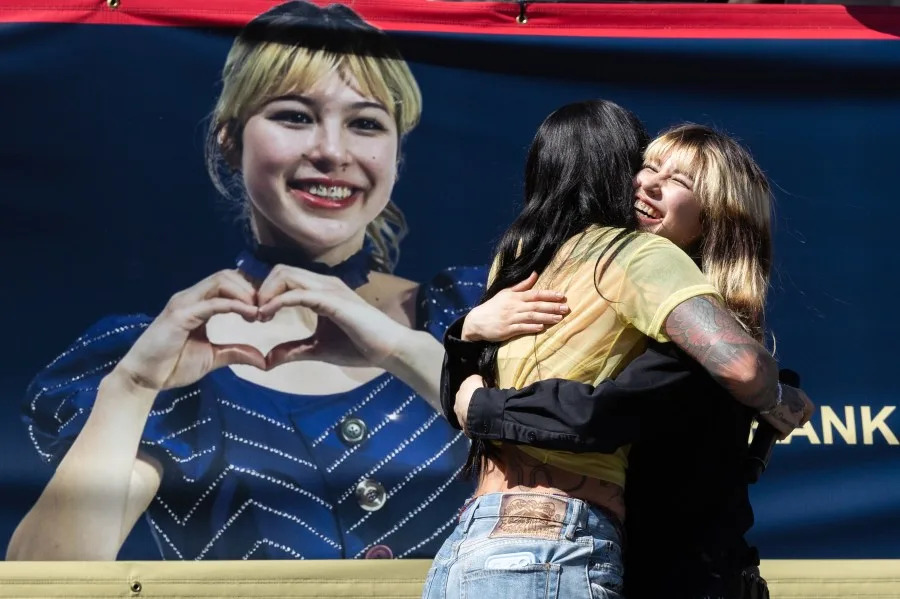 Musical artist Kehlani, left, embraces Olympic gold medalist Alysa Liu during a rally on March 12, 2026 in Oakland/ (Photo by Benjamin Fanjoy/Getty Images)