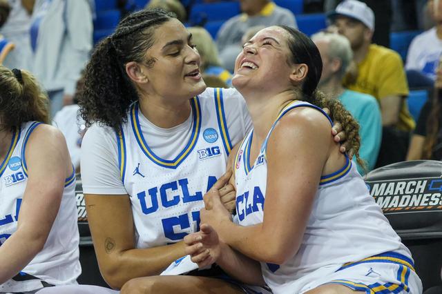 UCLA's Lauren Betts (51) and Charlisse Leger-Walker (5) celebrate together on the bench during an 87-68 win against Oklahoma State in the NCAA Tournament round of 32 at Pauley Pavilion on March 23, 2026, in Los Angeles. 