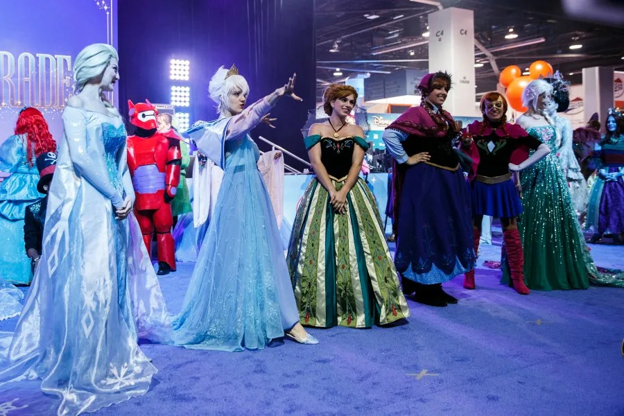 <em>Attendees dressed in costumes of characters from the Walt Disney Co.’s Frozen movie pose for the crowd during a costume contest at the D23 2015 in Anaheim (Patrick T. Fallon/Bloomberg via Getty Images)</em>